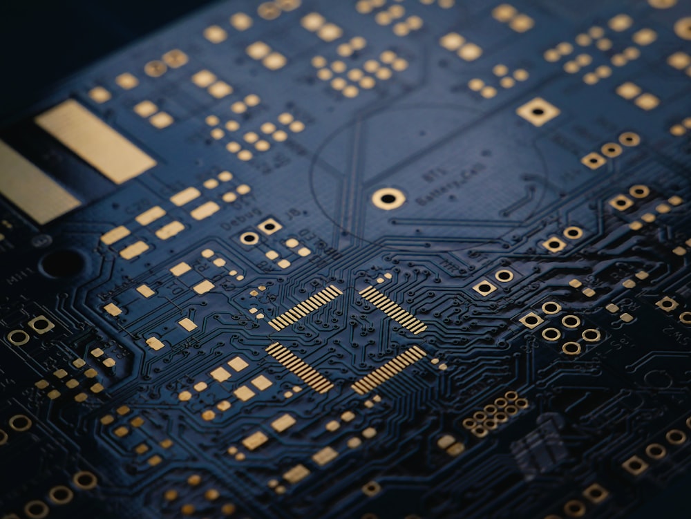Dark blue circuit board with gold traces